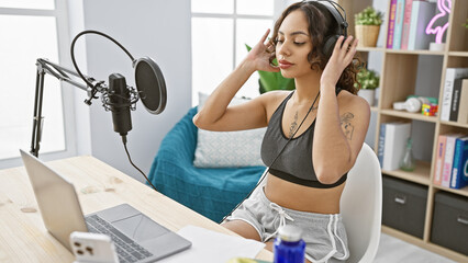 Young woman with headphones recording podcast in a modern studio interior, radiating creativity and...