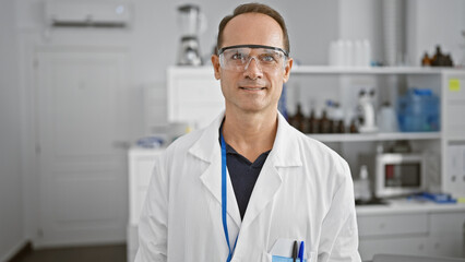 At the heart of science, a confident, smiling middle age man - our very own scientist, standing...