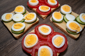Toasted bread with boiled eggs, tomatoes and cucumber slices 