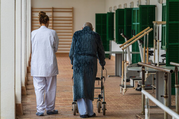 nurse accompanying an elderly man on a rehabilitation walk, Juan March Hospital, Bunyola, Majorca, Balearic Islands, Spain
