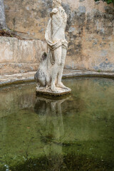 Fototapeta na wymiar decapitated sculpture in a pond, Raixa, public property, municipality of Bunyola, Majorca, Balearic Islands, Spain