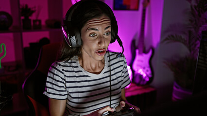 Confident and happy young hispanic woman streamer bringing her a-game! playing video stream at...