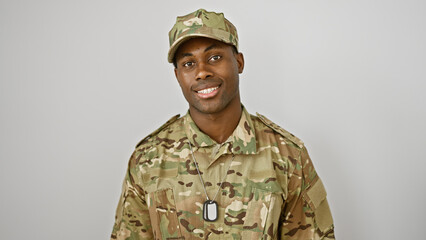 Smiling african american soldier in camouflage uniform posing against an isolated white background.