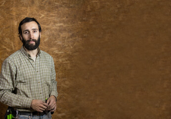 Horizontal photo confident carpenter mid adult caucasian with textured backdrop. Business concept.