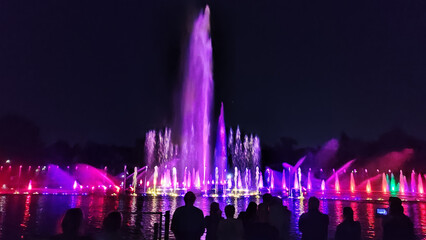Colourful dancing Illuminated fountain at the night, water flow