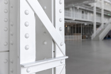 White steel truss pillar structure, close up photo, vintage industrial architecture