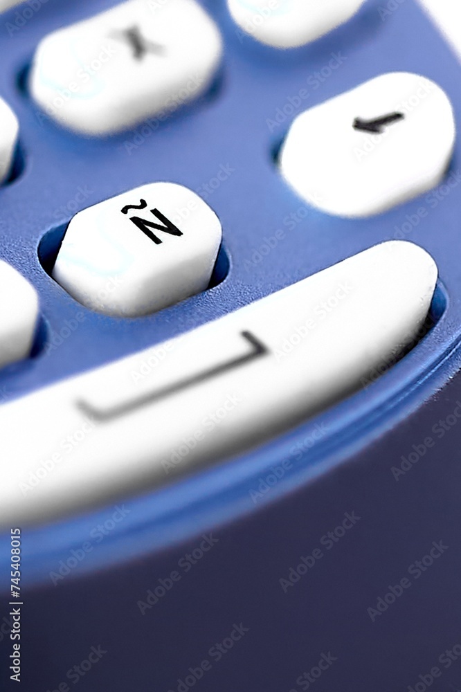 Poster image of an ñ key on a thermal labeling machine, with selective focus highlighting the key in the ce