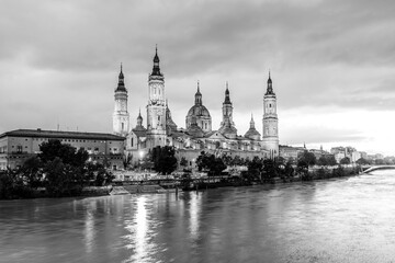 Evening landscape of the Cathedral Basilica of Our Lady of the Pillar on the banks of river Ebro in Zaragoza, Aragon, Spain in black and white - 745408044