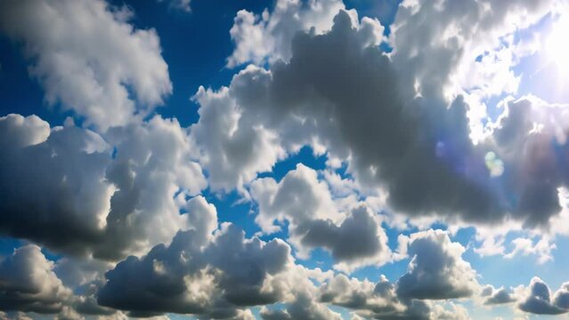 Blue sky adorned with fluffy white clouds in a bright summer day