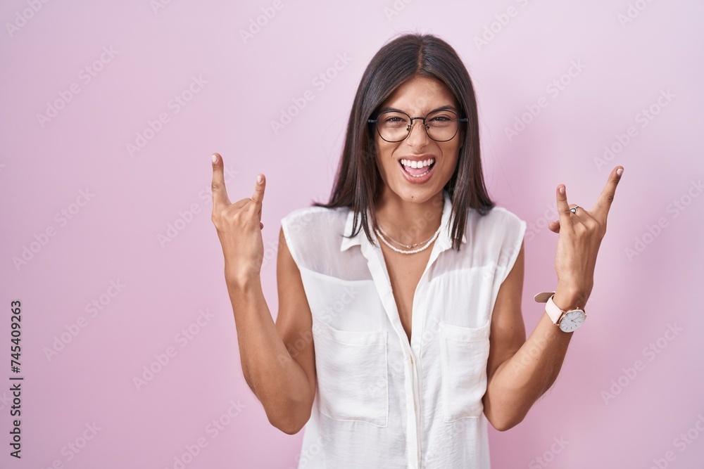 Canvas Prints brunette young woman standing over pink background wearing glasses shouting with crazy expression do