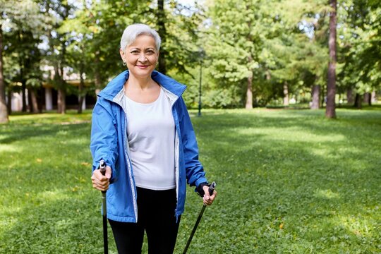 Fit Happy Gray Haired Mature Female Sportswear Enjoying Health Promoting Physical Activity Using Walking Poles Having Excited Joyful Facial Expression Breathing Fresh Air Wild Nature Smiling