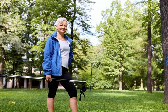 Health Well Being Vitality Recreation Activity Concept Outdoor Summer View Stylish Confident Sixty Year Old Female Posing Against Pine Trees Holding Nordic Walk Stick Smiling