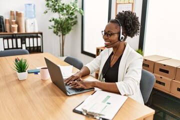 African american woman call center agent smiling confident working at office