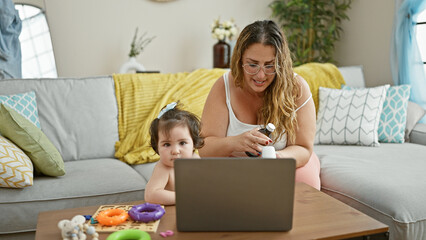 Loving mother and ill daughter, together on their sofa at home calling a doctor, engaging in a heartwarming online medical consultation