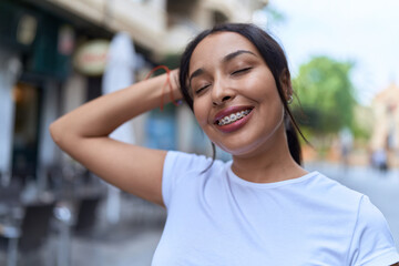 Young arab woman smiling confident at coffee shop terrace