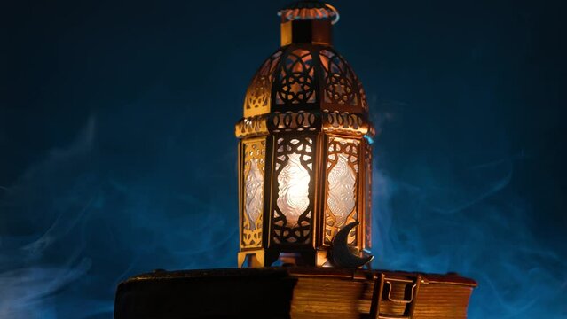 Ornamental Arabic lantern with burning candle glowing at night.Festive greeting card, invitation for Muslim holy month Ramadan Kareem.