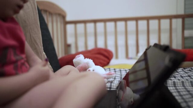 little girl watching cartoon on tablet on youtube