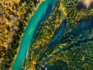 A drone view of the river in the forest. An aerial view of an forest. Winding river among the trees. Aerial landscape. Landscape with soft light before sunset. - 745426408