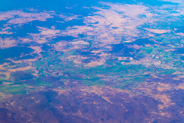 Flying airplane over Mexico Clouds Sky Volcanoes Mountains City desert.