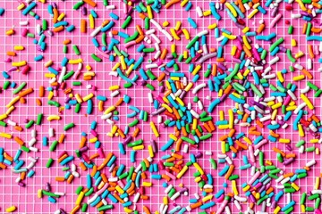 trendy pattern of colorful sprinkles for pie and cake for background design banner, poster, flyer, card, card, cover, brochure on pink background