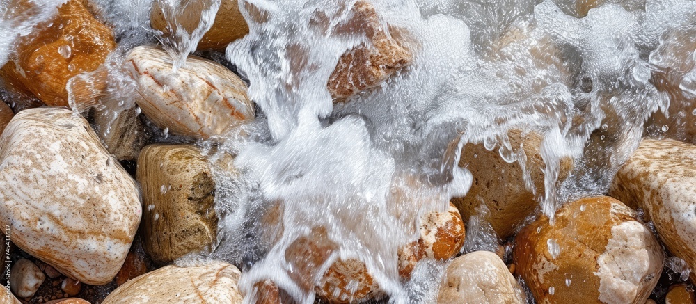 Poster a cluster of rocks with water gushing out of them, creating a dynamic and captivating sight. the for