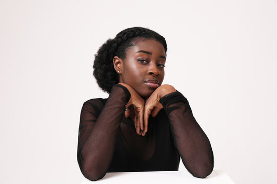 Portrait of young African American woman confidently looks at camera. Mock-up.