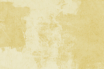 Old stucco plaster surface, concrete wall background, close up grunge texture of yellow painted...