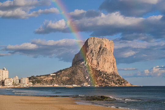 Panoramic view of the Natural Park Peñón de Ifach with a beautiful rainbow. Parc Natural del Penyal d'Ifac. Calp, Alicante, Spain.
