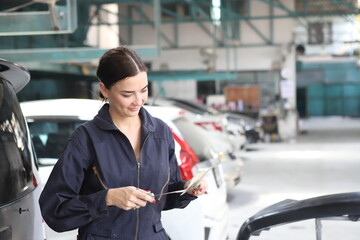 Auto mechanic working in garage. Repair service. Worker mechanics in uniform are working in auto...