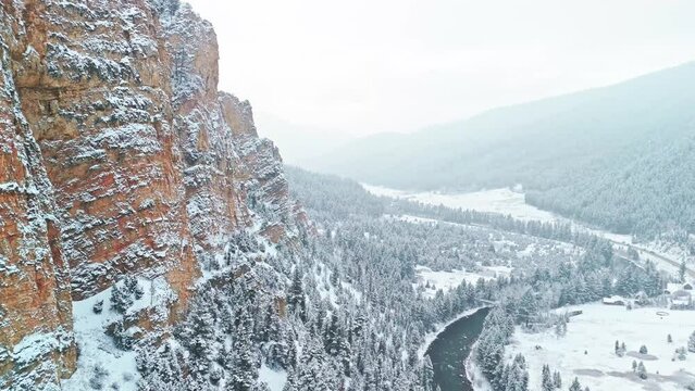 Snow covered mountains canyon through the river road  aerial view