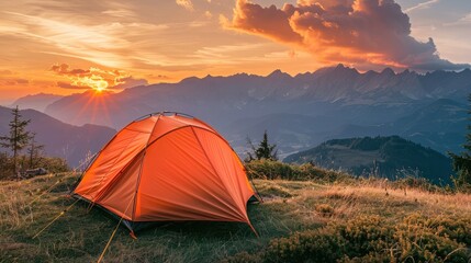 Obraz premium Glowing orange tent in the mountains under dramatic evening sky. Red sunset and mountains in the background. Summer landscape.