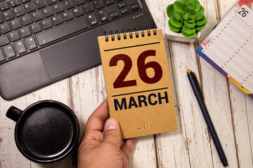 March 26th. Image of march 26 wooden color calendar on blue background. Spring day, empty space for...