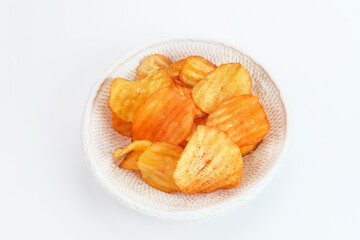 Potato Chips, served in bowl on white background.
