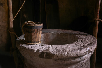 Antique wooden bucket on historic monastery kitchen   - obrazy, fototapety, plakaty