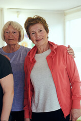 A vibrant community of senior women, guided by their instructor, embraces the enriching journey of yoga, fostering unity, well-being, and a shared commitment to active aging