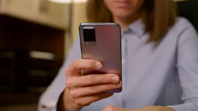 Close-up shot of woman&rsquo;s hands holding smartphone, typing on phone screen. Female chats online, shops on internet, browses the web, downloads a new app. Modern wireless technology concept.