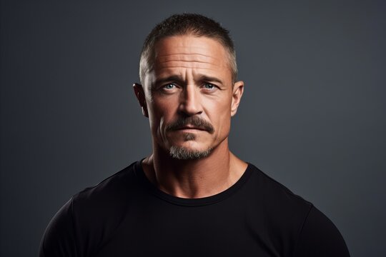 Portrait of a serious mature man in a black T-shirt.
