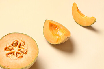 Cut sweet melon on orange background