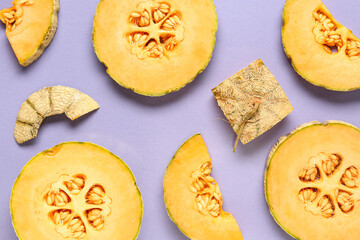 Pieces of sweet melon on lilac background