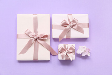 Gift boxes and beautiful hydrangea flowers on lilac background. International Women's Day