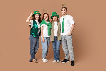 Fototapeta premium Group of people with decor on beige background. St. Patrick's Day celebration