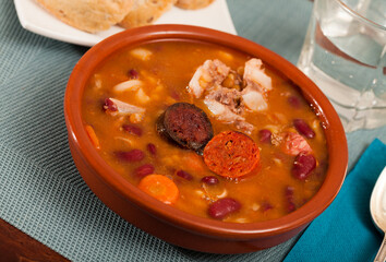 Fabada asturiana - beans stewed with chorizo and bacon served on clay pot