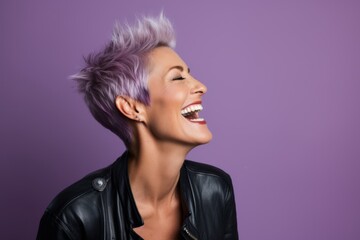 Portrait of a beautiful young woman with short purple hair on a purple background