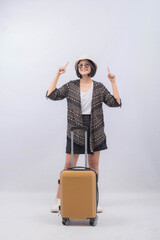 Portrait of Young Asian Woman carrying suitcase for vacation