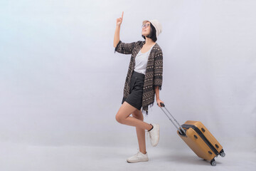 Portrait of Young Asian Woman carrying suitcase for vacation