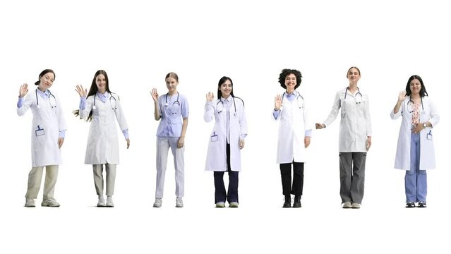 A group of doctors, in full height, on a white background, waving their hands