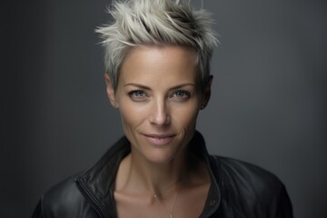 Fototapeta na wymiar Portrait of a beautiful woman with short blond hair in a leather jacket