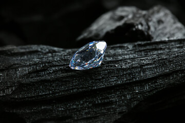 Beautiful shiny diamond on coal, closeup view