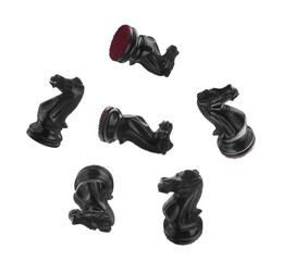Black wooden chess knights falling on white background © New Africa