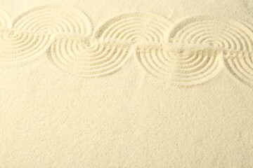 Fototapeta na wymiar Zen rock garden. Wave pattern on beige sand